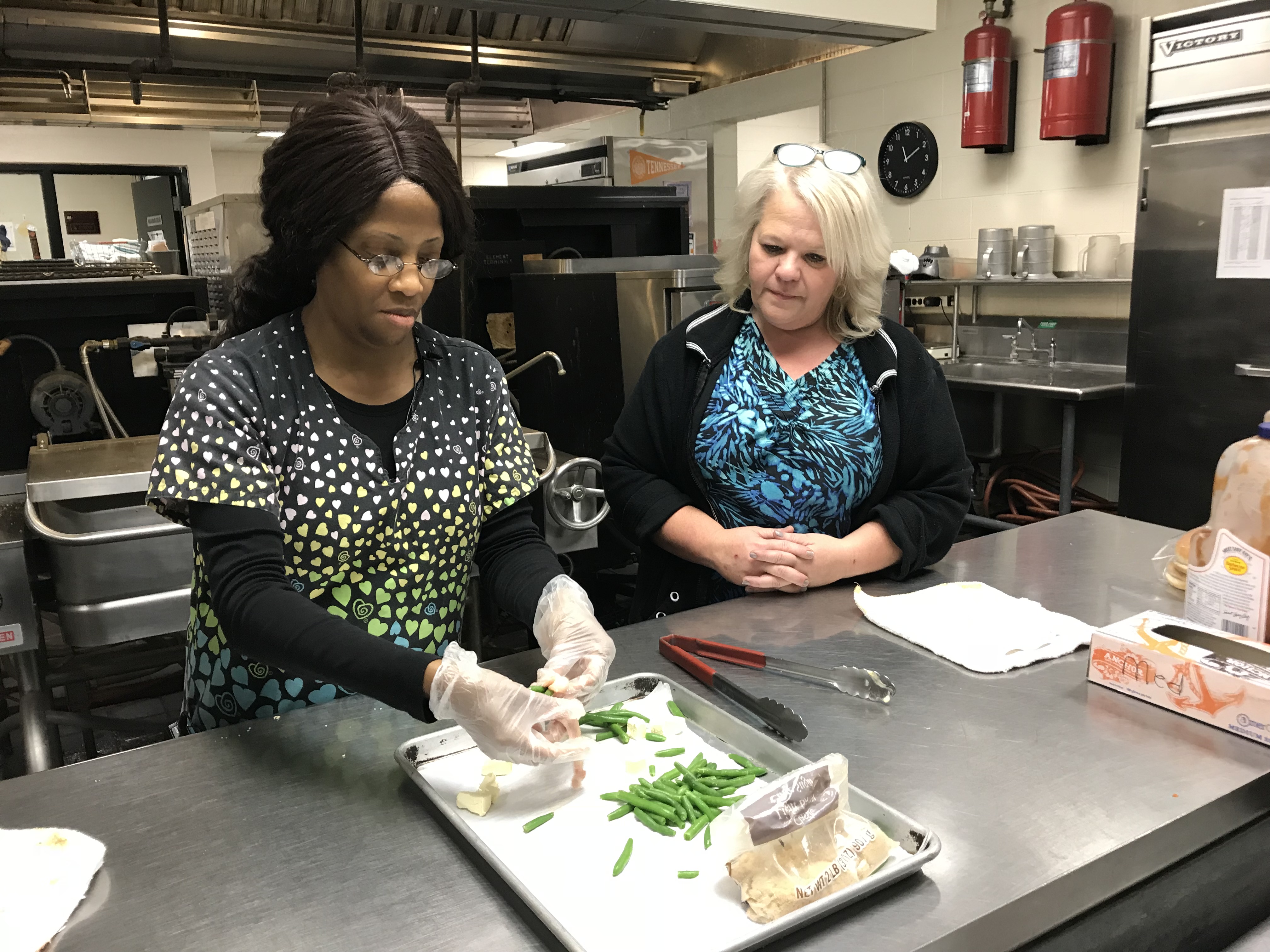 Cherrie Dirl and Karen Householder prepare Green Bean Bundles at the Powell High School kitchen on Nov. 14, 2018. 